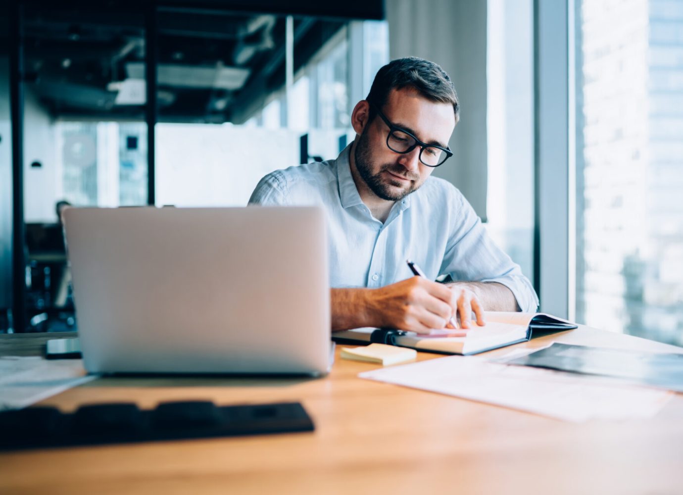 man working behind laptop