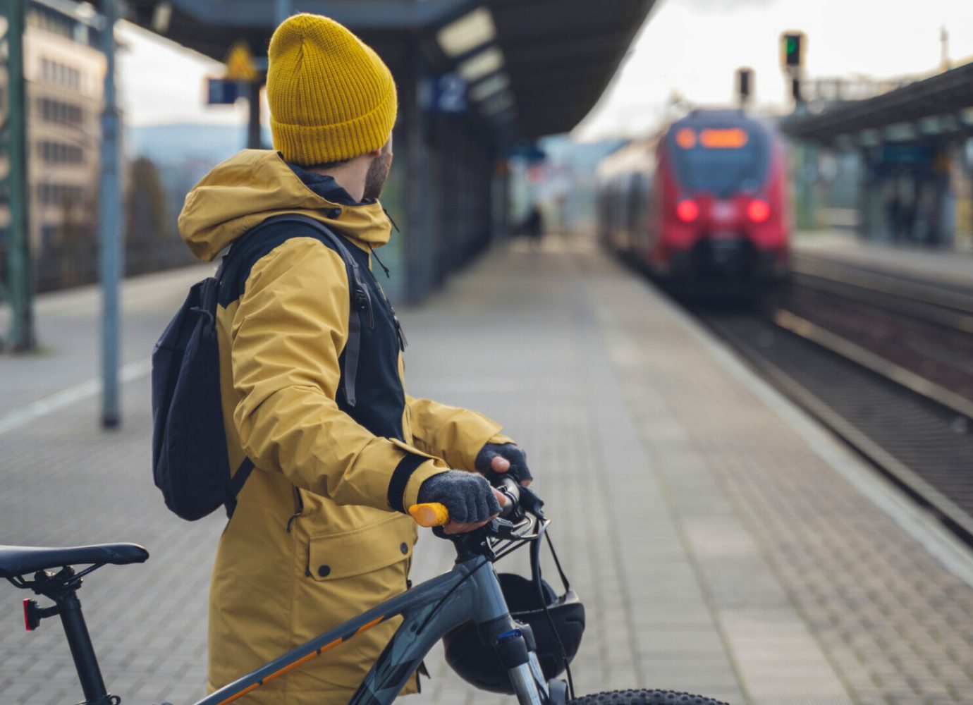 man with bike waiting for the train